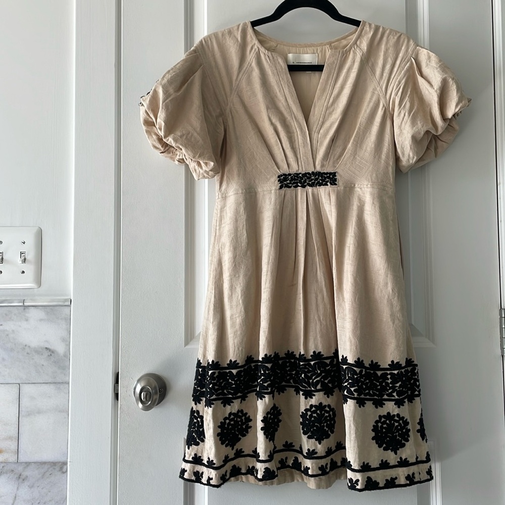 Intricate, knee-length summer dress by Anthropologie with hidden pockets.